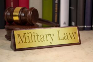 Sign adorned with a gavel and symbolizing military law in gold.